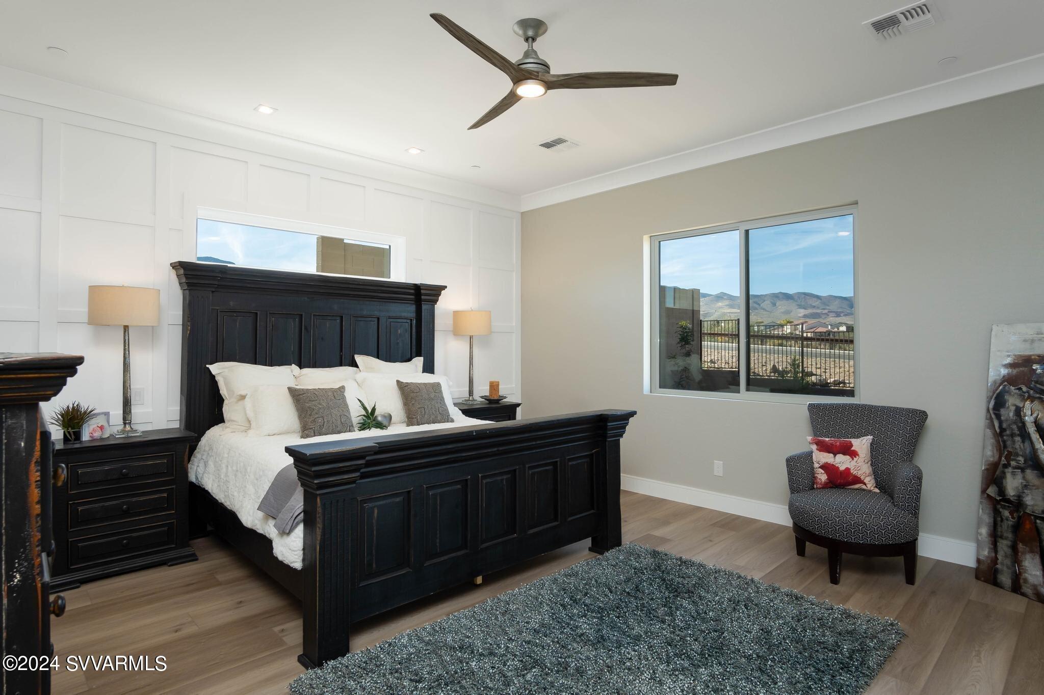 699 Moore Gulch Road, Unit LOT 117 Clarkdale, AZ 86324 - Photo 30 of 81 a bedroom with a bed and wooden floor