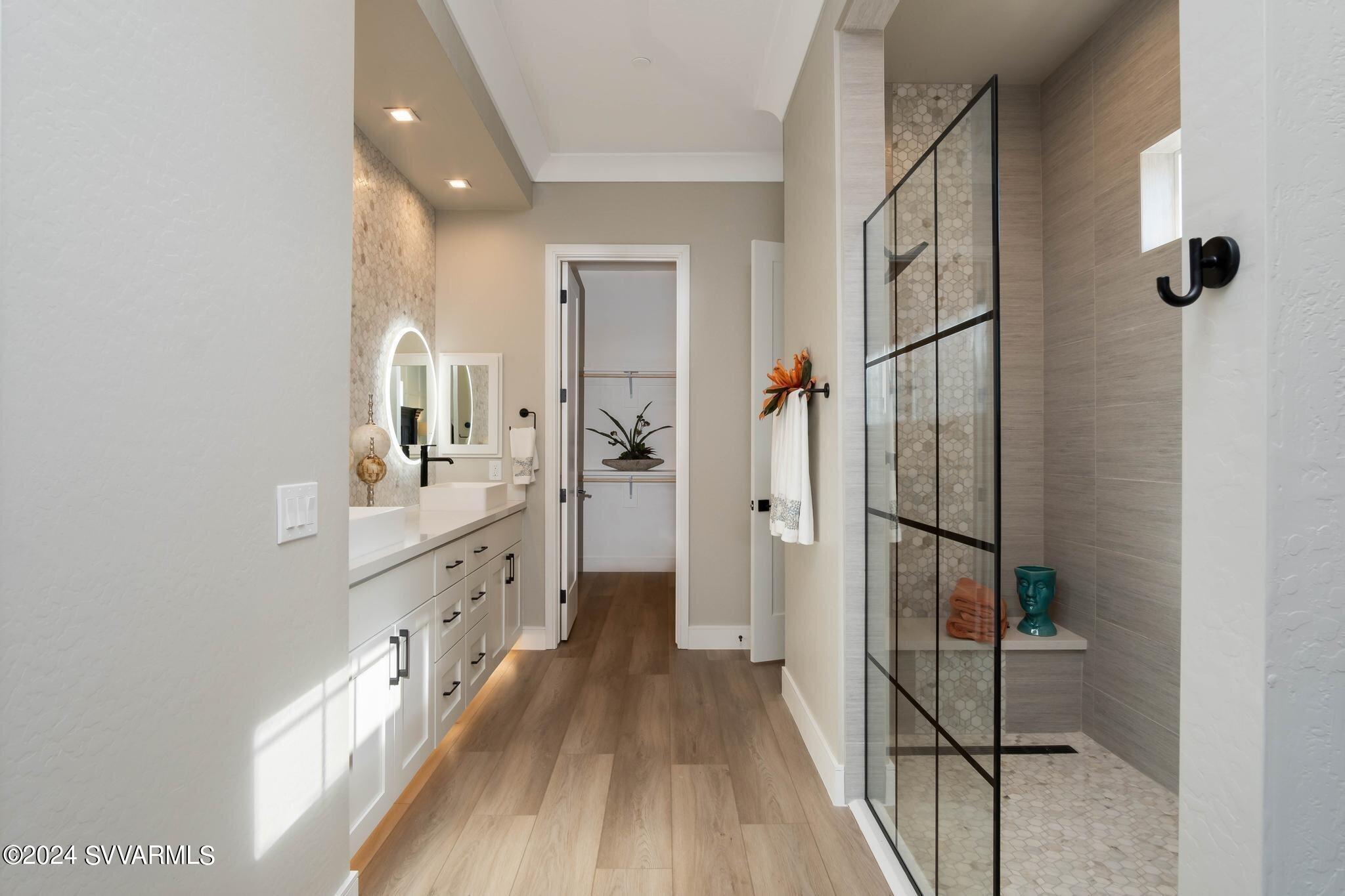 699 Moore Gulch Road, Unit LOT 117 Clarkdale, AZ 86324 - Photo 34 of 81 a spacious bathroom with a double vanity sink and a mirror