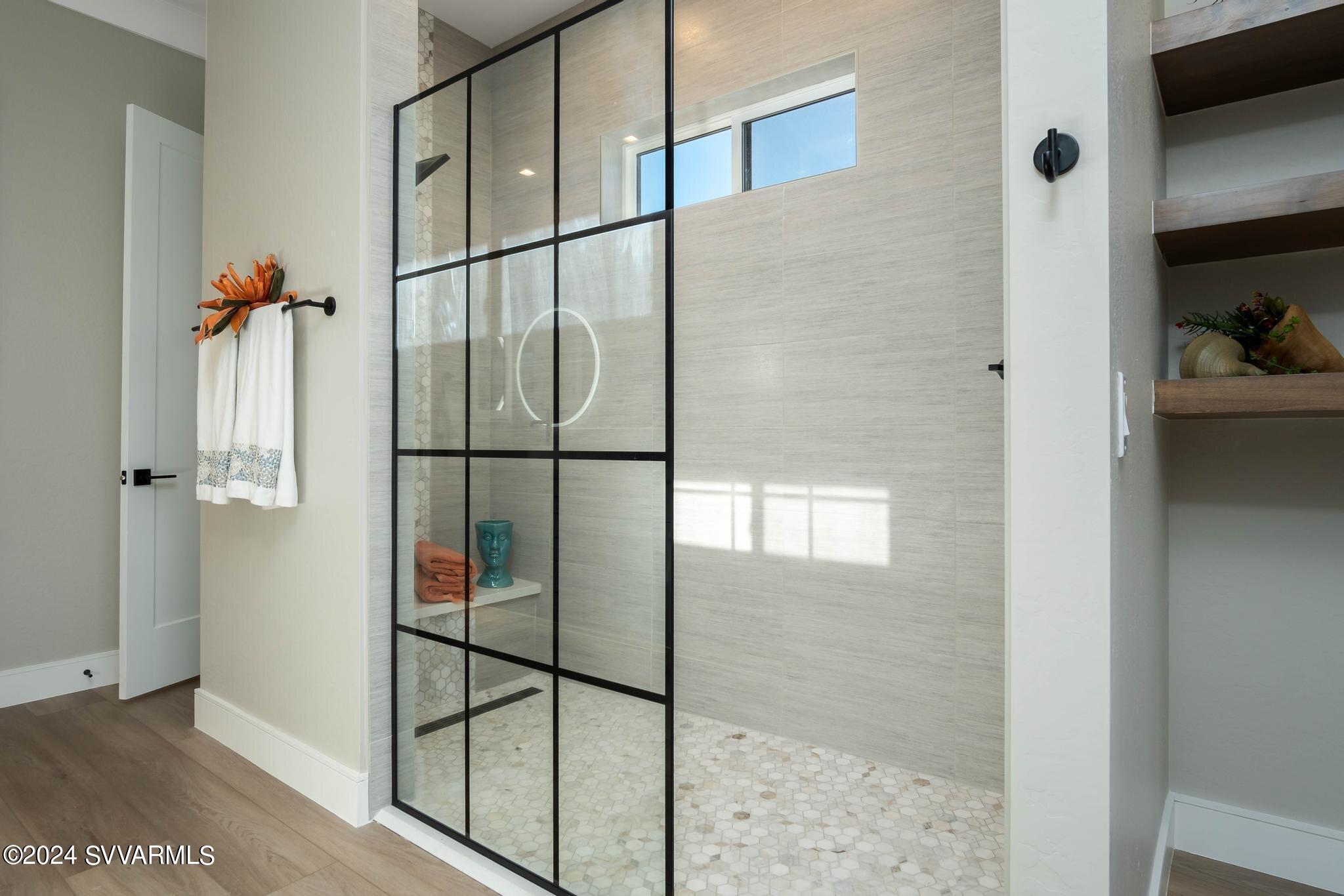699 Moore Gulch Road, Unit LOT 117 Clarkdale, AZ 86324 - Photo 36 of 81 a bathroom with a glass shower door