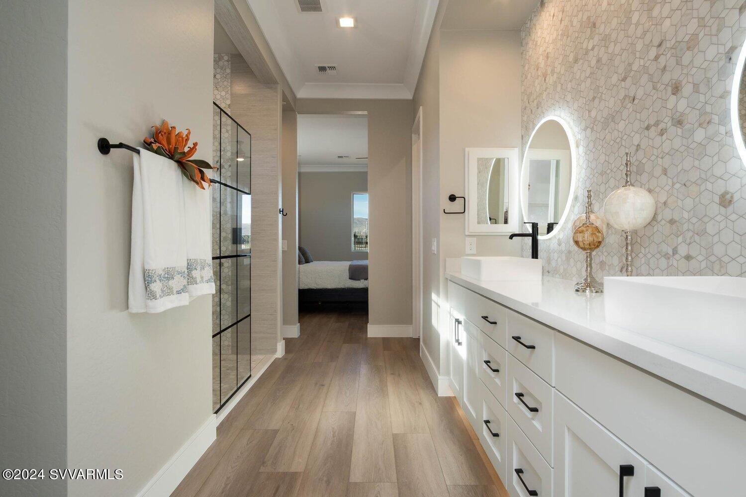699 Moore Gulch Road, Unit LOT 117 Clarkdale, AZ 86324 - Photo 39 of 81 a spacious bathroom with a double vanity sink and mirror