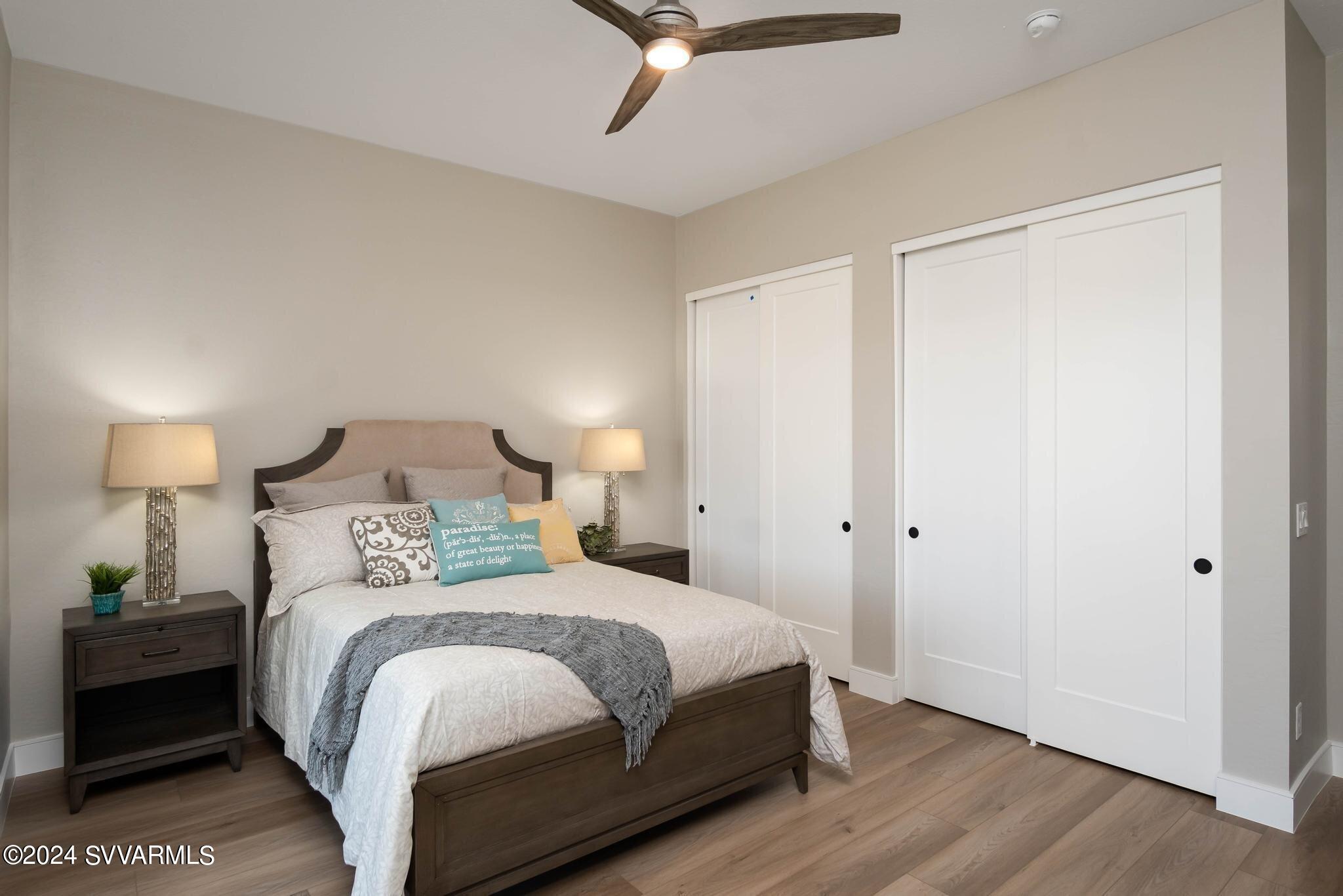 699 Moore Gulch Road, Unit LOT 117 Clarkdale, AZ 86324 - Photo 42 of 81 a bedroom with a bed and a ceiling fan