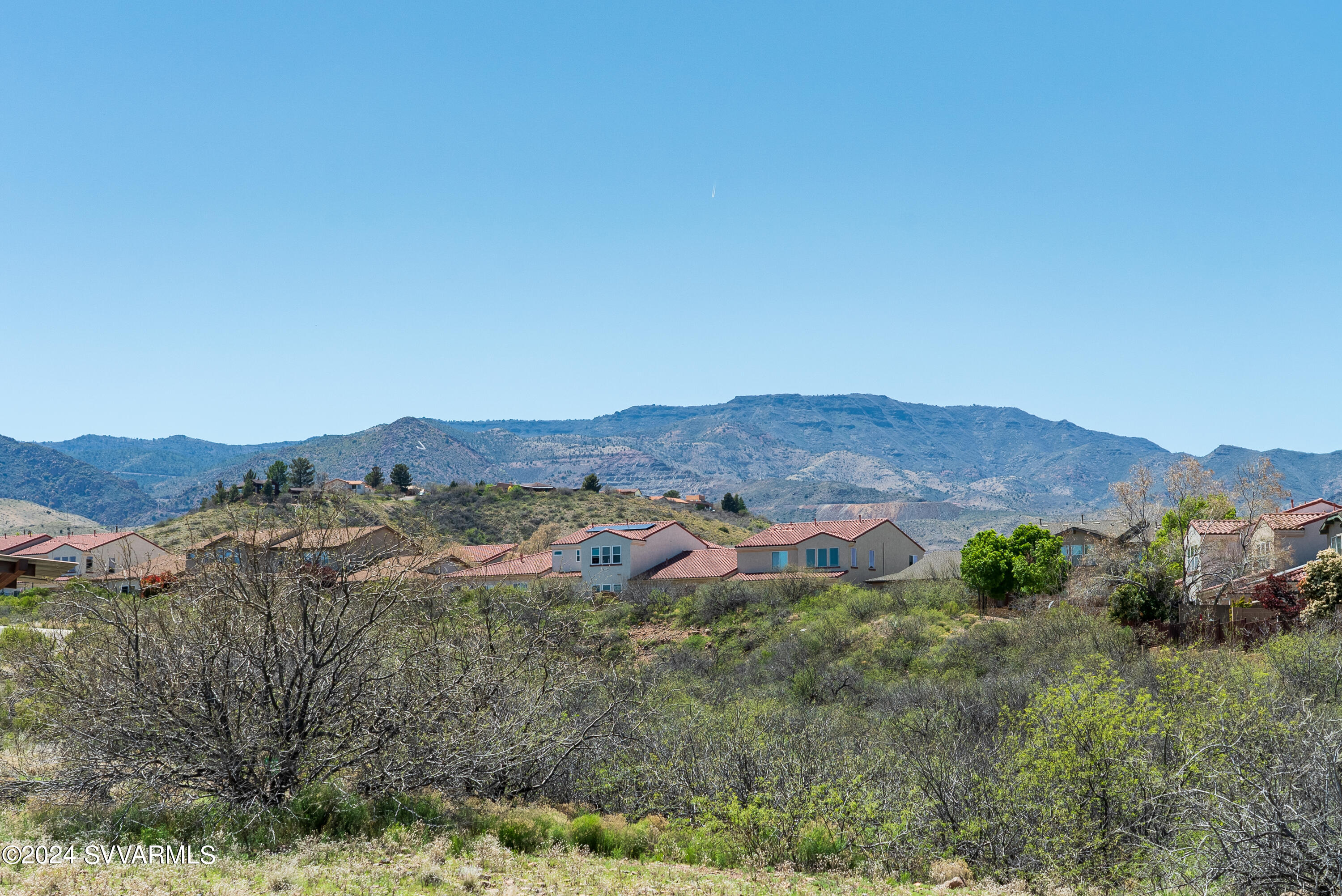 699 Moore Gulch Road, Unit LOT 117 Clarkdale, AZ 86324 - Photo 5 of 81 a view of a lush green field with mountains in the background