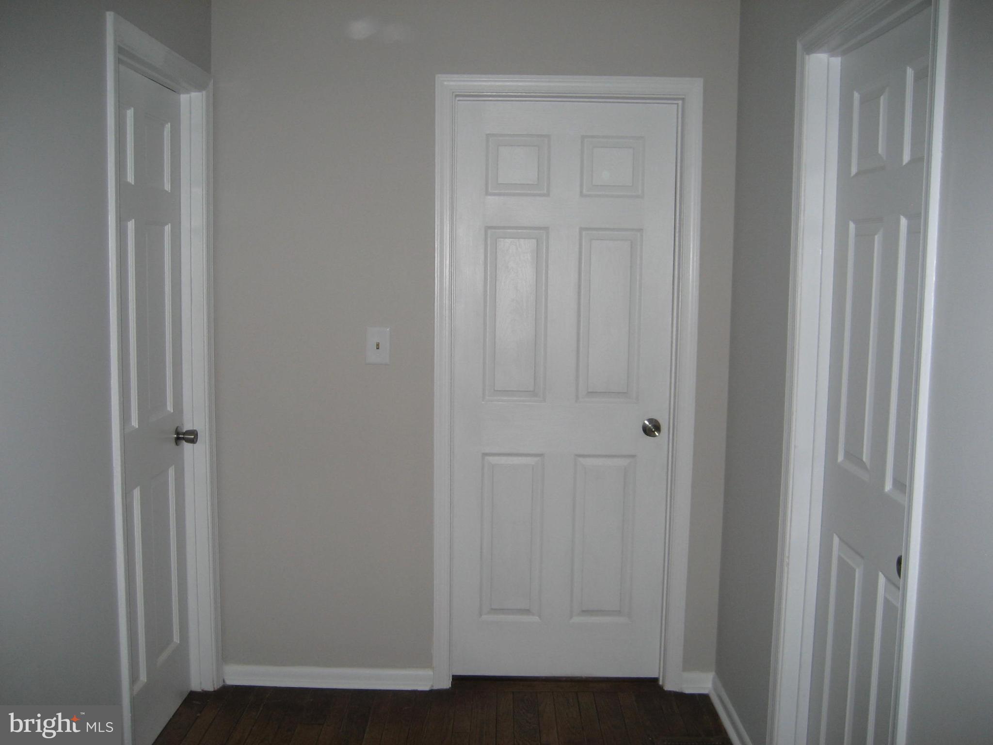 4577 Dave Rill Road Hampstead, MD 21074 - Photo 21 of 31 Upstairs Hall, 3 Bedroom Doors visible