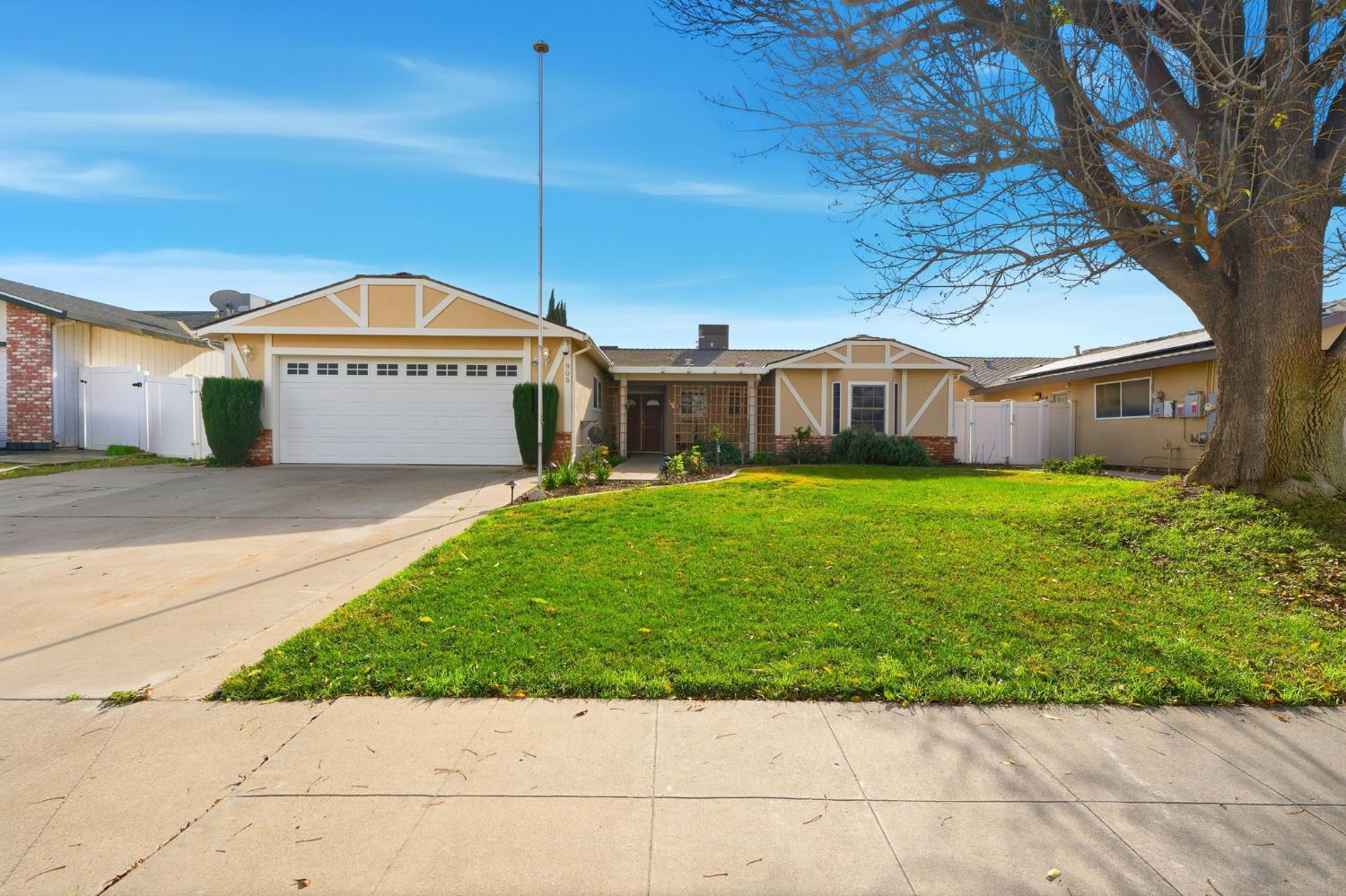 905 Redwood Lane Lemoore, CA 93245 - Photo 2 of 56 a view of a house with a yard and large tree
