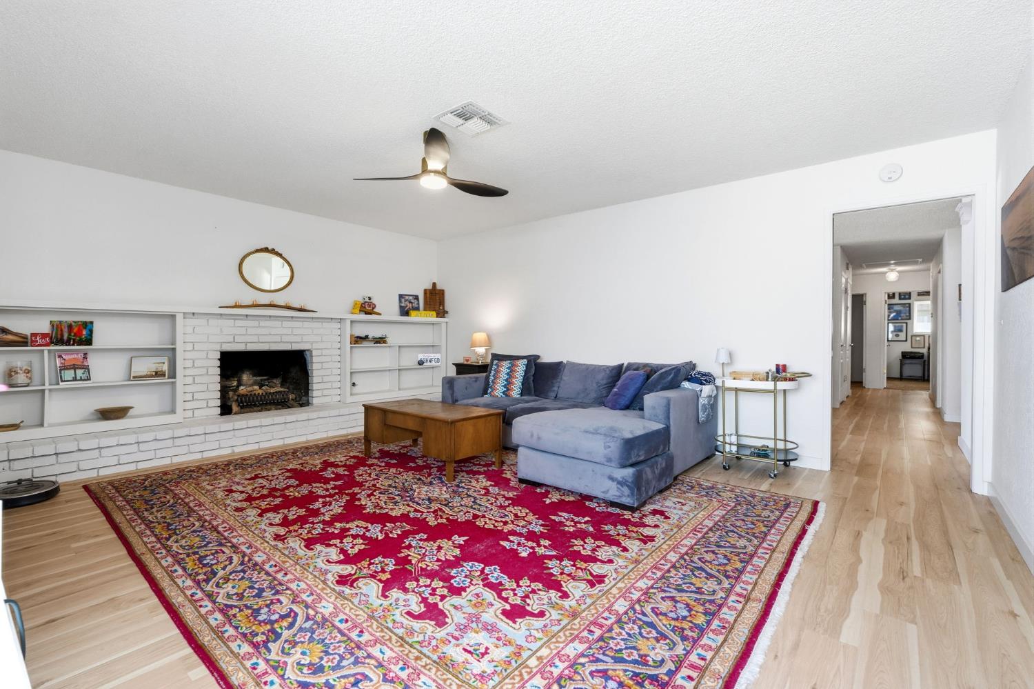 905 Redwood Lane Lemoore, CA 93245 - Photo 21 of 56 a living room with furniture and a fireplace