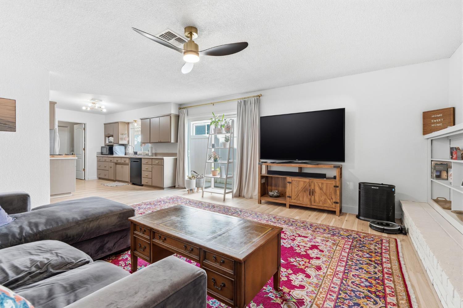 905 Redwood Lane Lemoore, CA 93245 - Photo 23 of 56 a living room with furniture and a flat screen tv