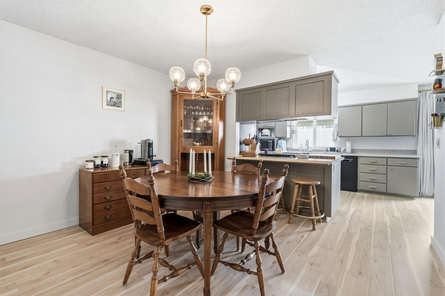 905 Redwood Lane Lemoore, CA 93245 - Photo 29 of 56 a view of a dining room with furniture a chandelier and wooden floor