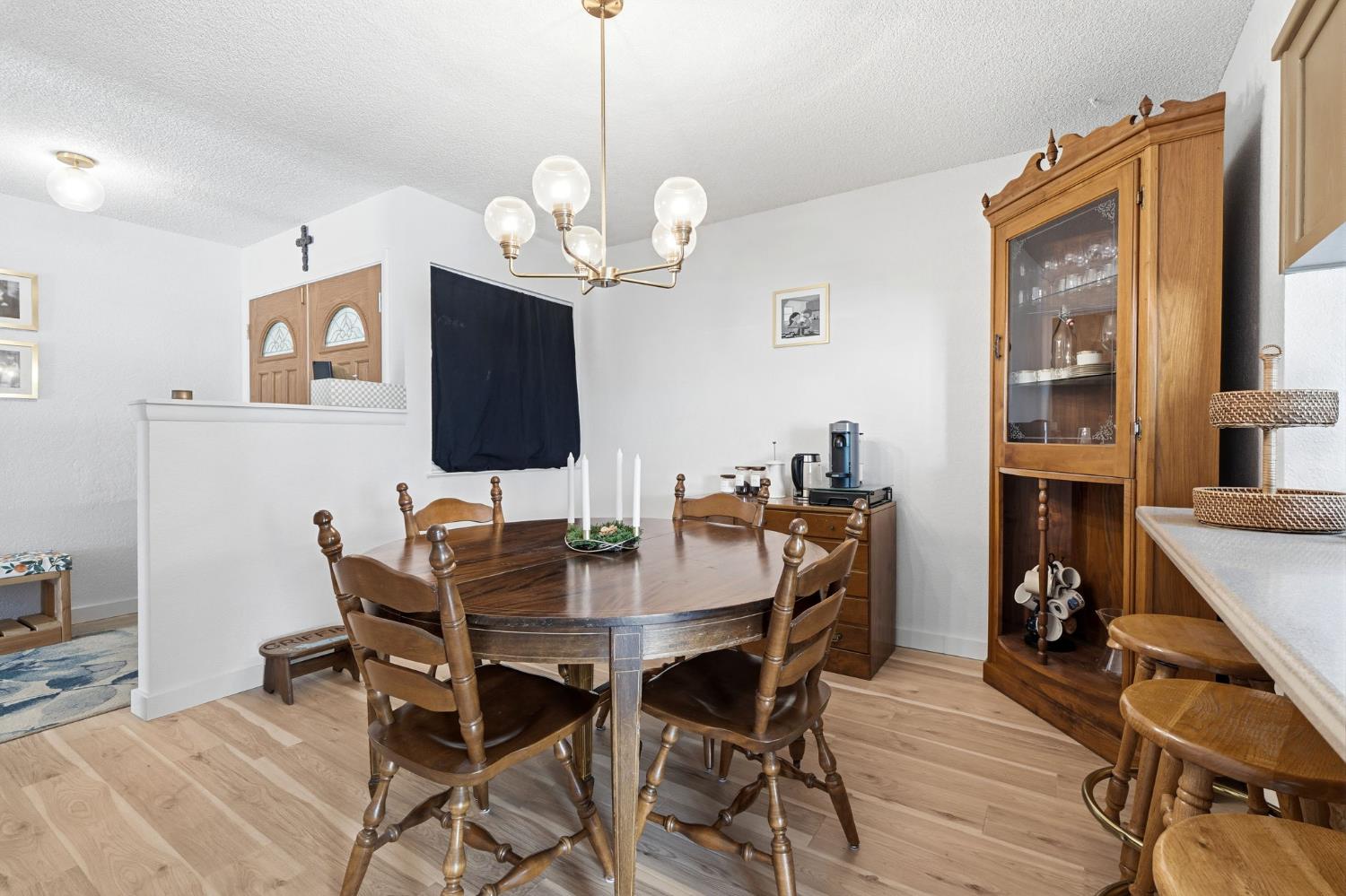 905 Redwood Lane Lemoore, CA 93245 - Photo 30 of 56 a view of a dining room with furniture a chandelier and wooden floor