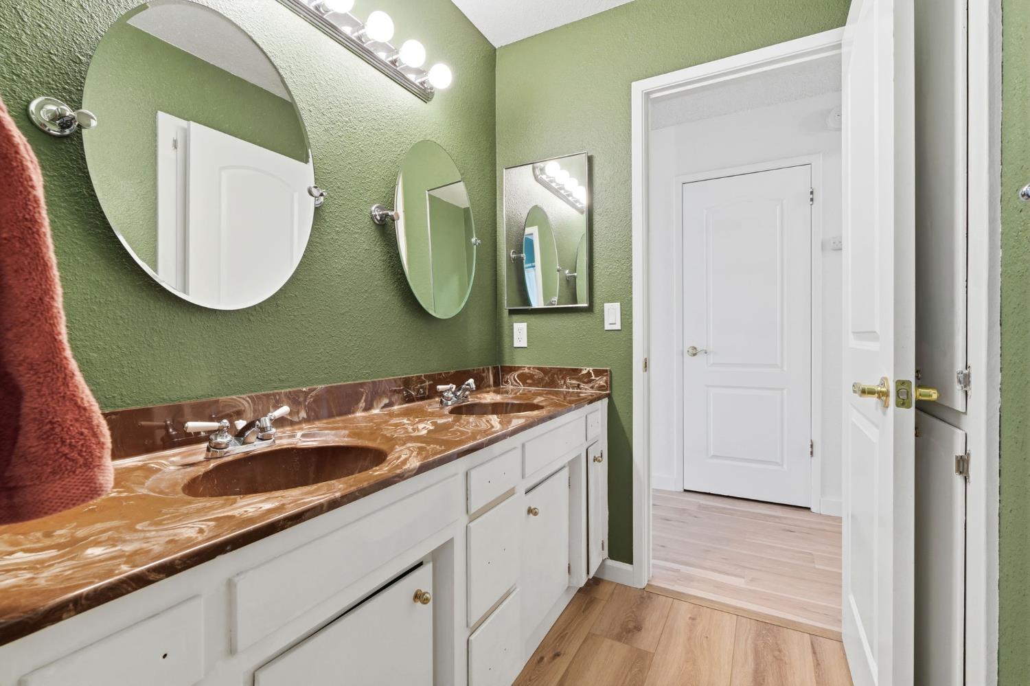 905 Redwood Lane Lemoore, CA 93245 - Photo 33 of 56 a bathroom with a sink and a mirror