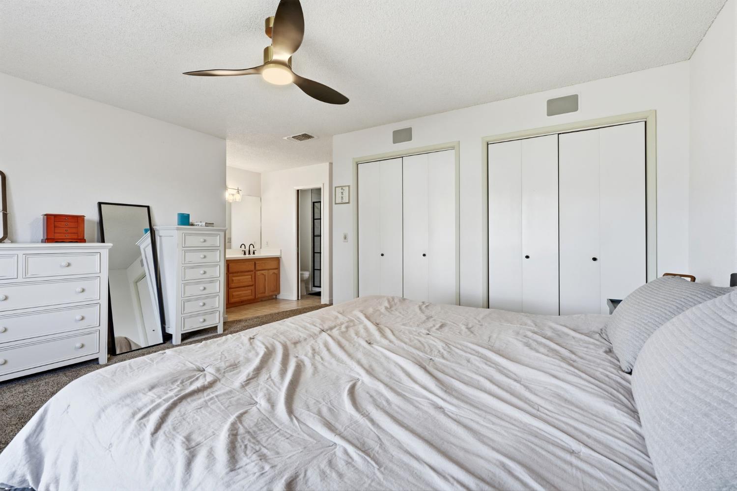 905 Redwood Lane Lemoore, CA 93245 - Photo 43 of 56 a bedroom with a bed and cabinets