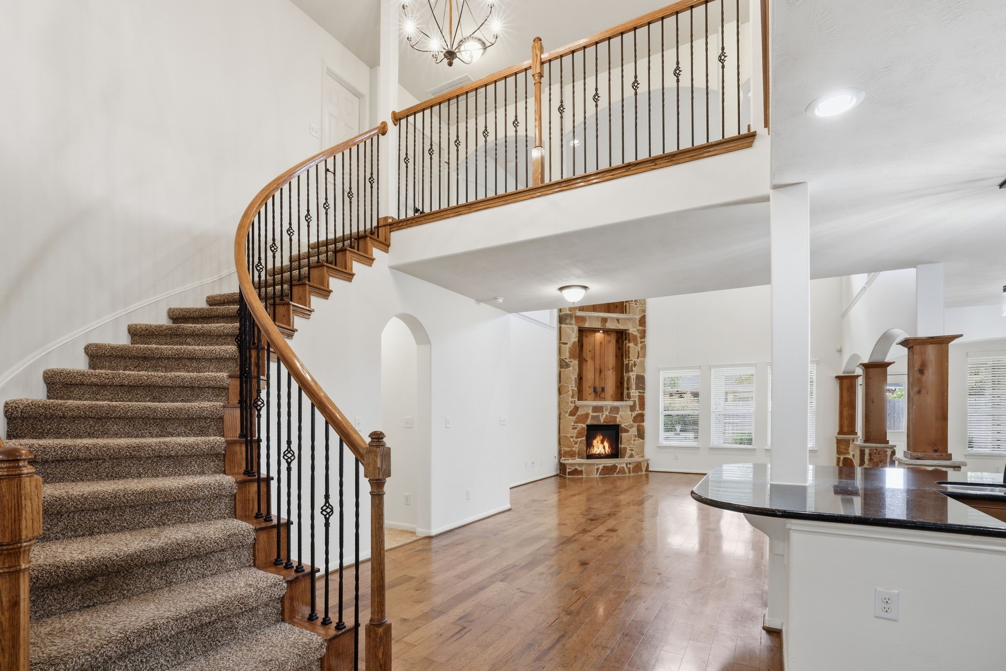 8169 Tranquil Lake Way Conroe, TX 77385 - Photo 6 of 26 a view of staircase with lots of frames on wall and wooden floor