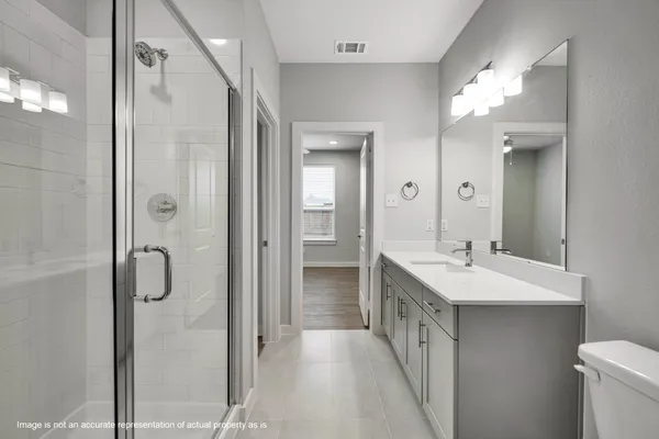a bathroom with a double vanity sink mirror and shower