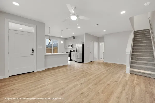 a view of an empty room with a kitchen