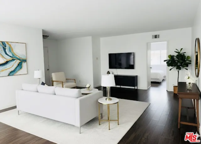 a living room with furniture fireplace and flat screen tv