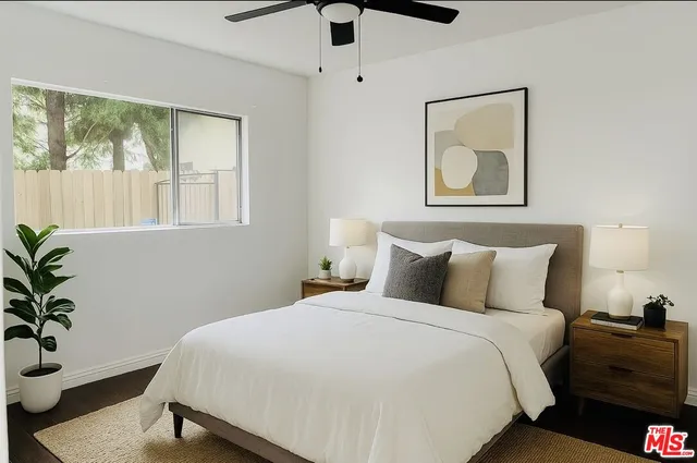 a bedroom with a bed and a potted plant