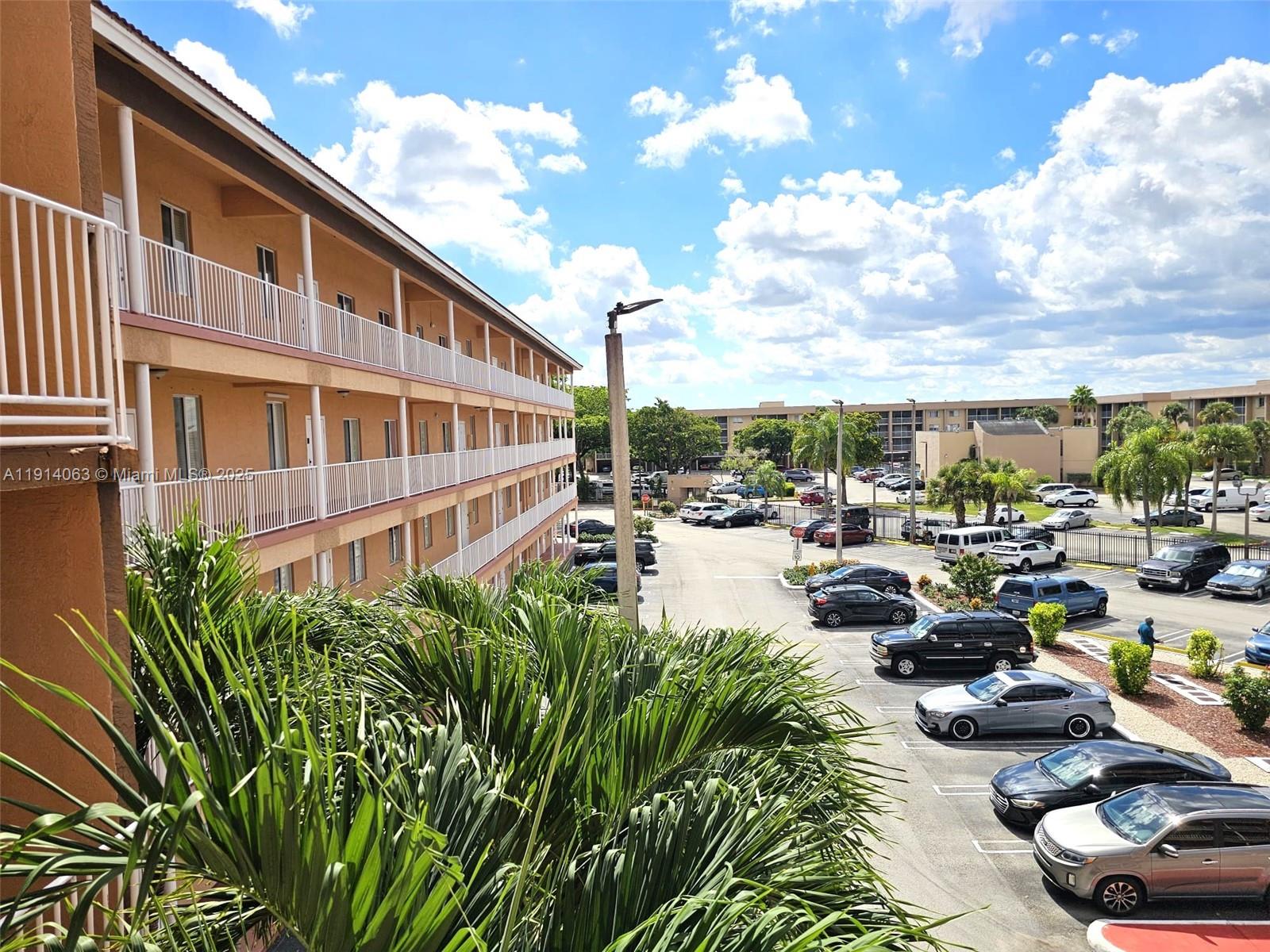 17350 Northwest 67th Avenue, Unit 303 Hialeah, FL 33015 - Photo 6 of 10 a city view with lot of cars parked on road