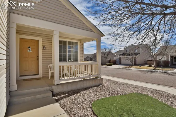 a view of a house with a large tree