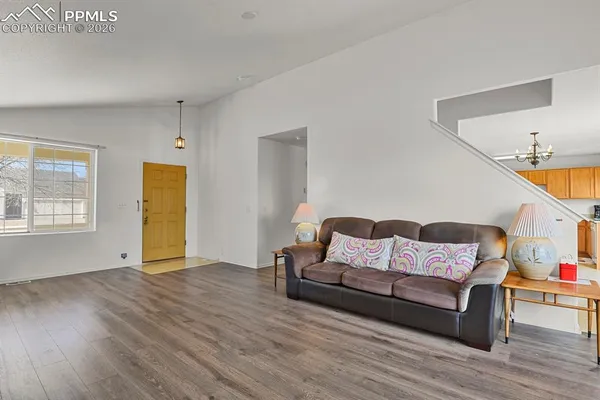 a living room with furniture and wooden floor