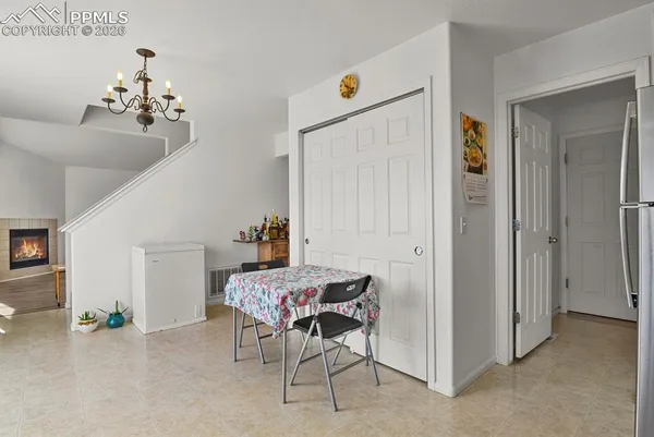 a dining room with furniture and chandelier