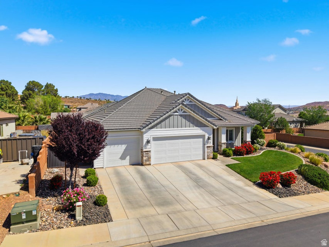 2829 East 1880th Street South St. George, UT 84790 - Photo 5 of 54 View of front of property with a garage, board and batten siding, stone siding, concrete driveway, and a mountain view