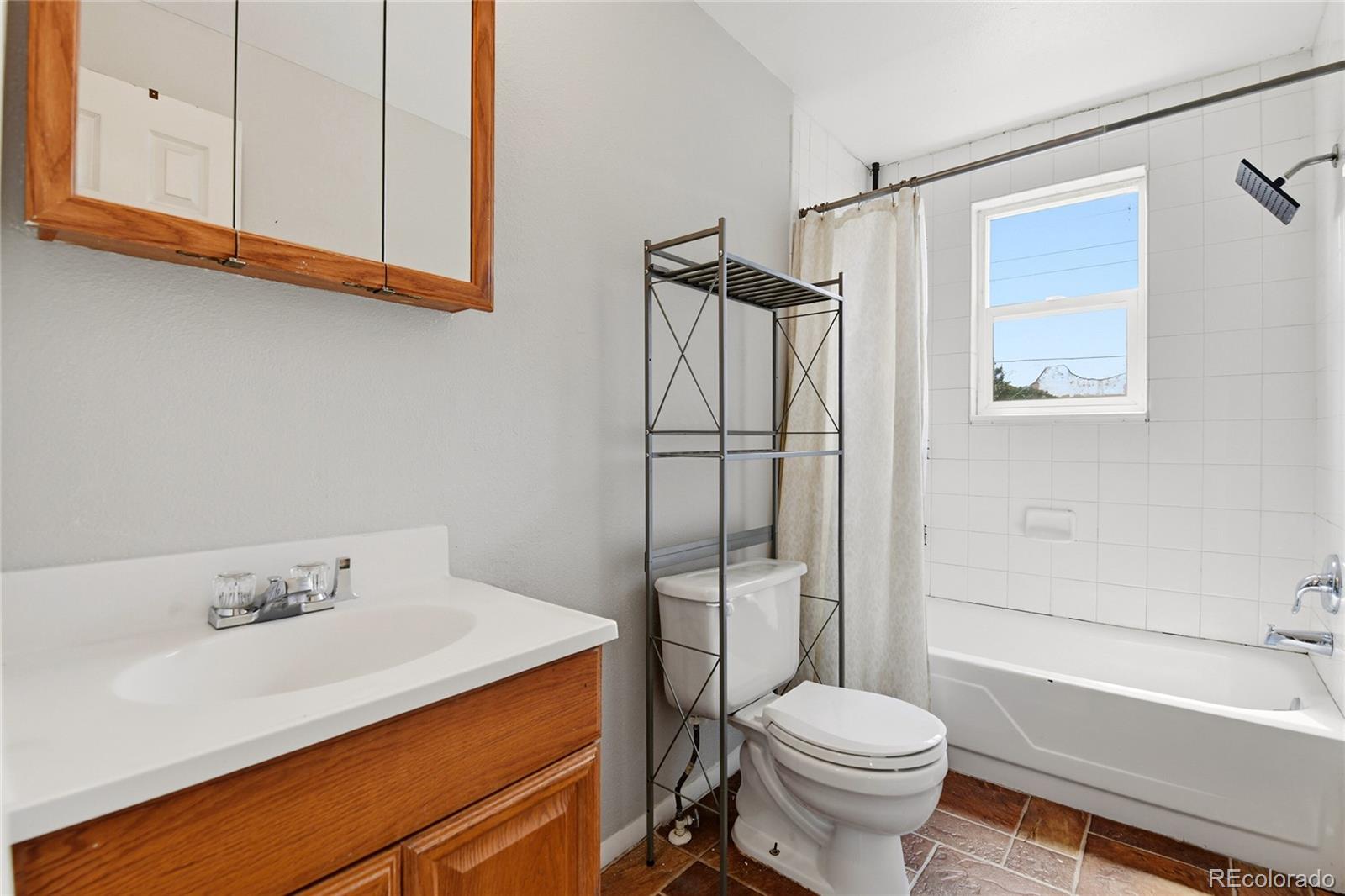 7461 Webster Street Arvada, CO 80003 - Photo 21 of 31 a bathroom with a sink toilet and shower