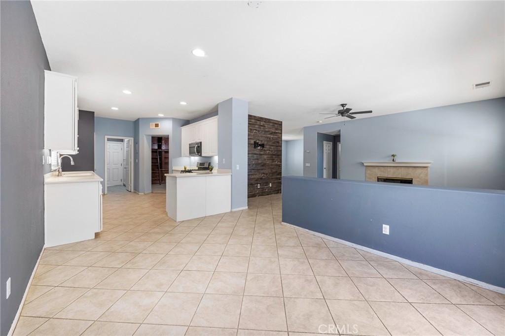 151 Ropango Way Hemet, CA 92545 - Photo 11 of 28 a kitchen with stainless steel appliances kitchen island granite countertop a refrigerator and a stove top oven