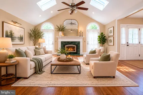 a living room with furniture and a large mirror with potted plants