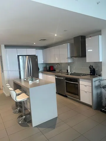 a kitchen with a stove a sink and a refrigerator