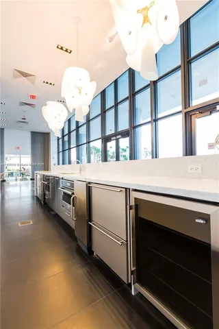 a living room with patio furniture and a large window