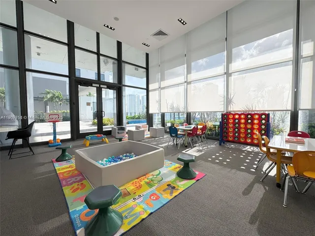 a view of a dining room with furniture and a floor to ceiling window