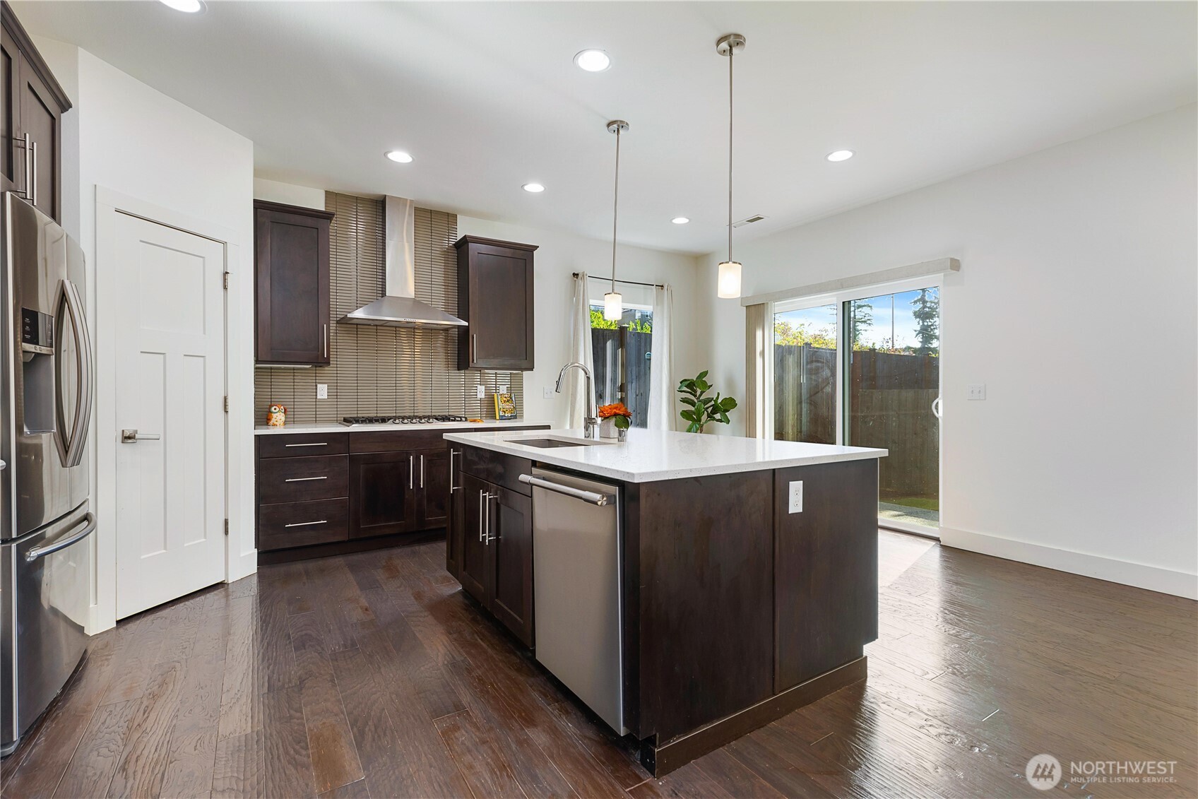 4214 223rd Place Southeast Bothell, WA 98021 - Photo 13 of 37 an open kitchen with wooden floor and stainless steel appliances