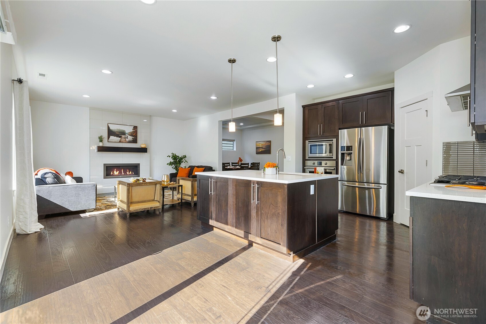 4214 223rd Place Southeast Bothell, WA 98021 - Photo 16 of 37 a living room with stainless steel appliances kitchen island granite countertop lots of furniture and a refrigerator