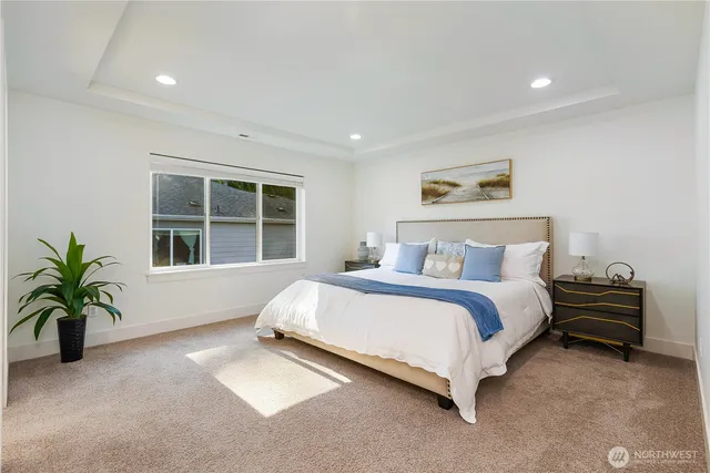 a spacious bedroom with a bed and glass window