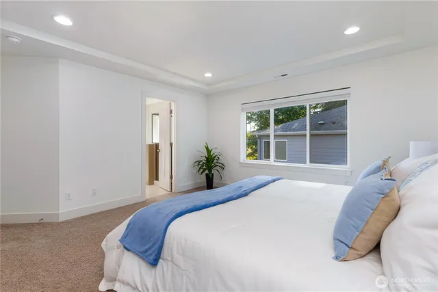 a bedroom with a large bed and a window