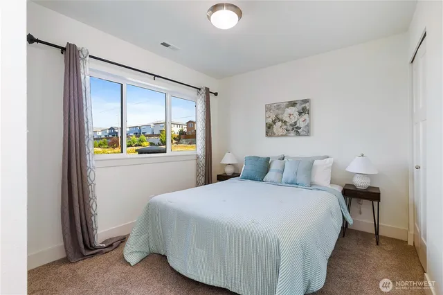 a bedroom with a bed and a window