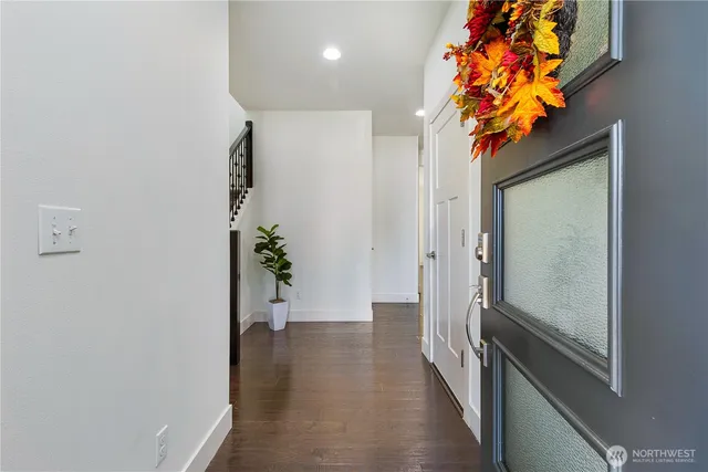 a view of a hallway with wooden floor and a flower pot