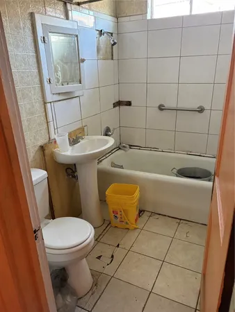 a bathroom with a sink a toilet and bathtub