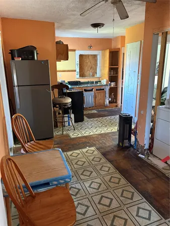 a kitchen with stainless steel appliances granite countertop a refrigerator and a stove