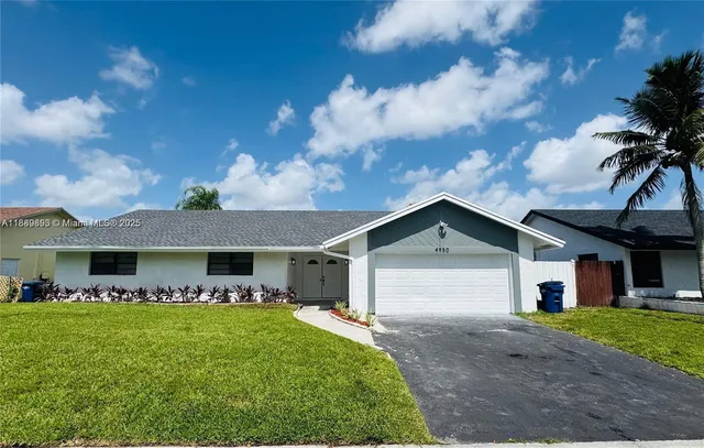 a front view of house with yard and green space