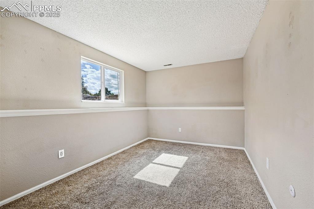 1248 Jet Wing Drive Colorado Springs, CO 80916 - Photo 14 of 25 an empty room with a window
