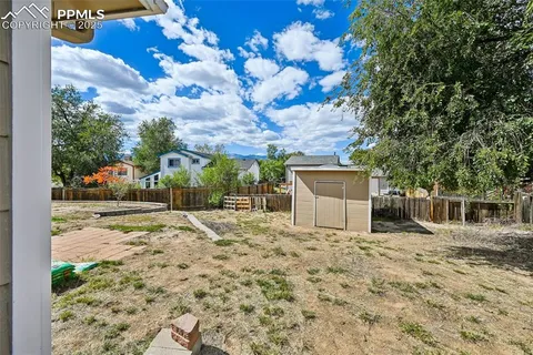 a view of a house with a yard and potted plants