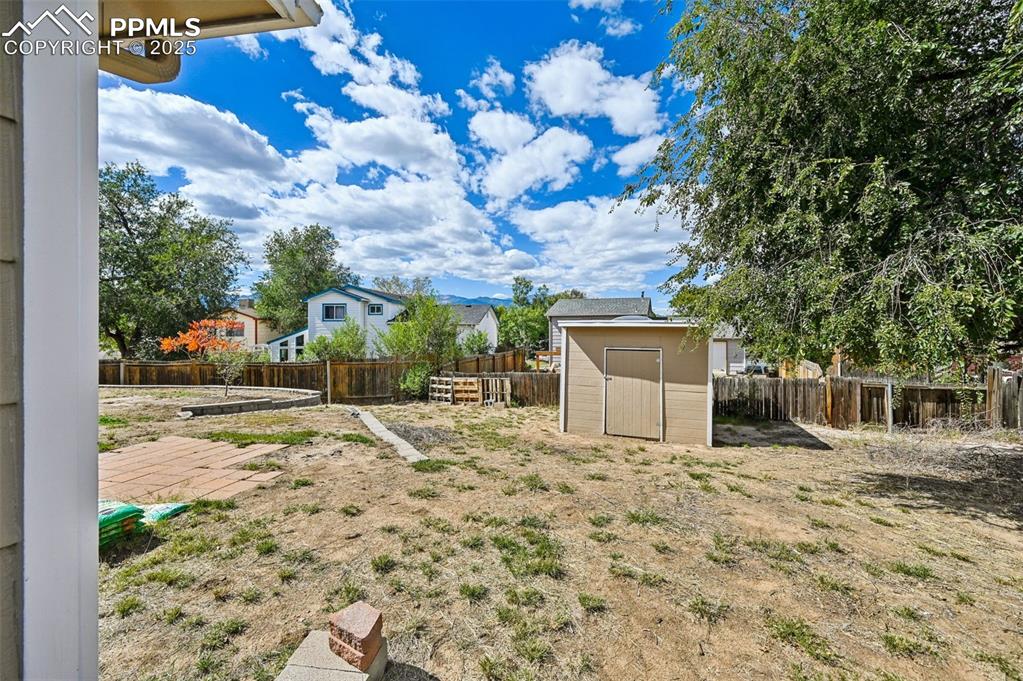 1248 Jet Wing Drive Colorado Springs, CO 80916 - Photo 18 of 25 a view of a house with a yard and potted plants