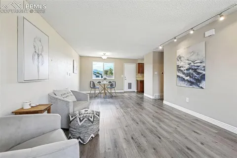 a living room with furniture and wooden floor