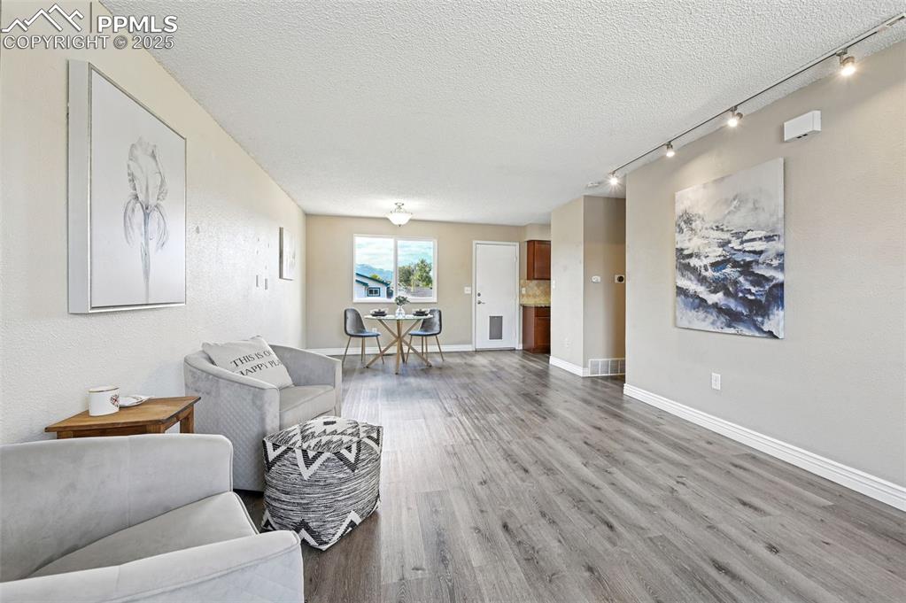 1248 Jet Wing Drive Colorado Springs, CO 80916 - Photo 24 of 25 a living room with furniture and wooden floor