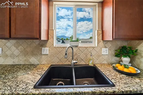 a bathroom with a granite countertop sink a mirror and a bathtub
