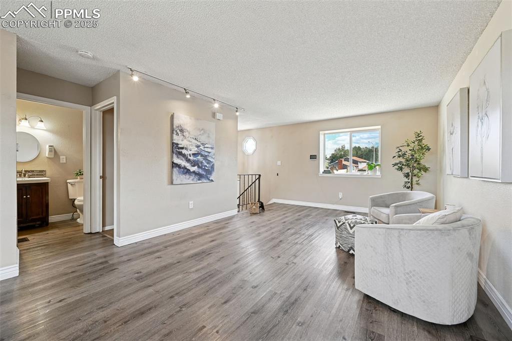 1248 Jet Wing Drive Colorado Springs, CO 80916 - Photo 10 of 25 a living room with furniture and a wooden floor