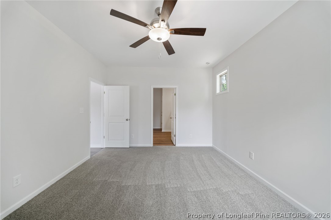 4038 Lofton Street Wade, NC 28395 - Photo 16 of 29 a view of an empty room with a ceiling fan