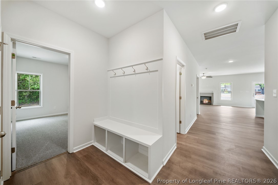 4038 Lofton Street Wade, NC 28395 - Photo 2 of 29 a view of a hallway with wooden floor and a kitchen