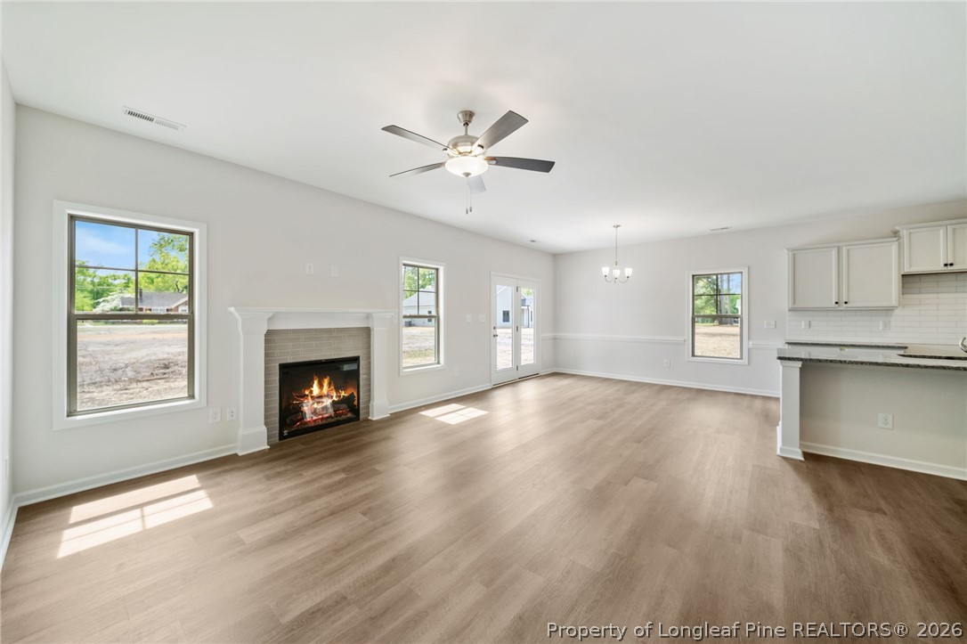4038 Lofton Street Wade, NC 28395 - Photo 3 of 29 a view of an empty room with a fireplace and a window