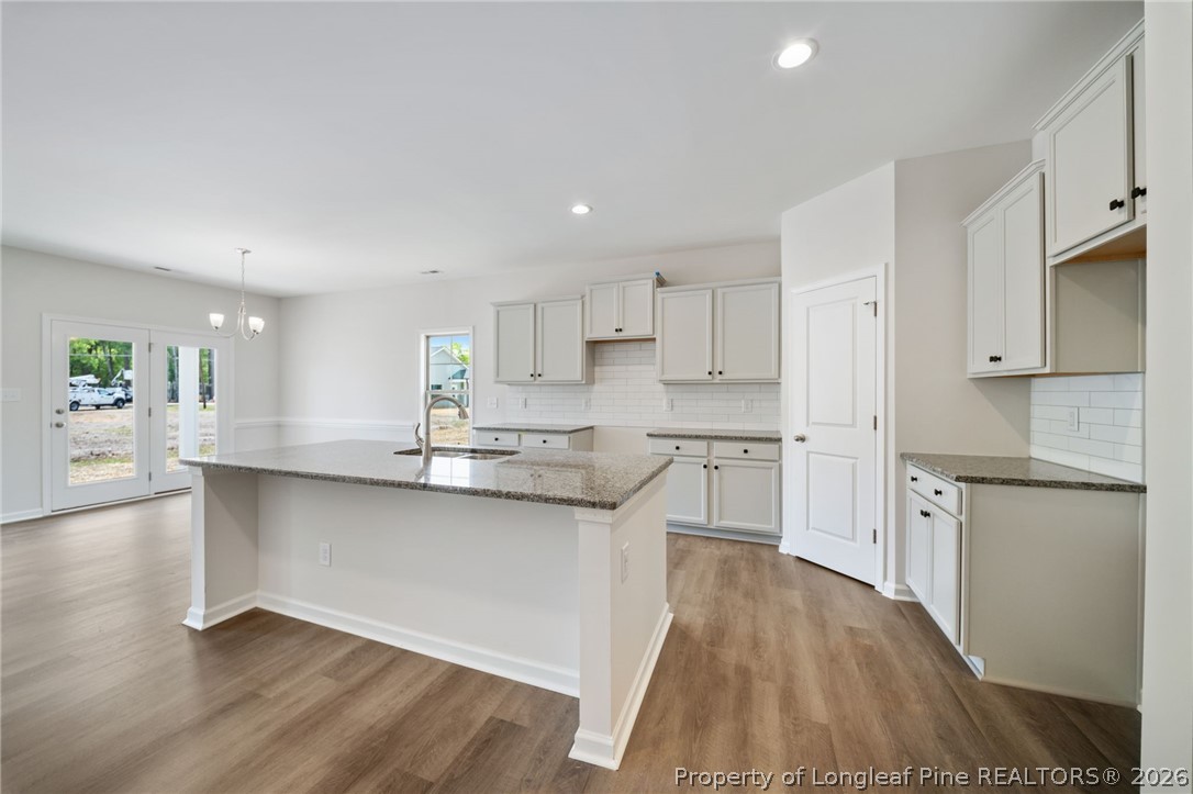 4038 Lofton Street Wade, NC 28395 - Photo 5 of 29 a kitchen with stainless steel appliances a sink cabinets and wooden floor
